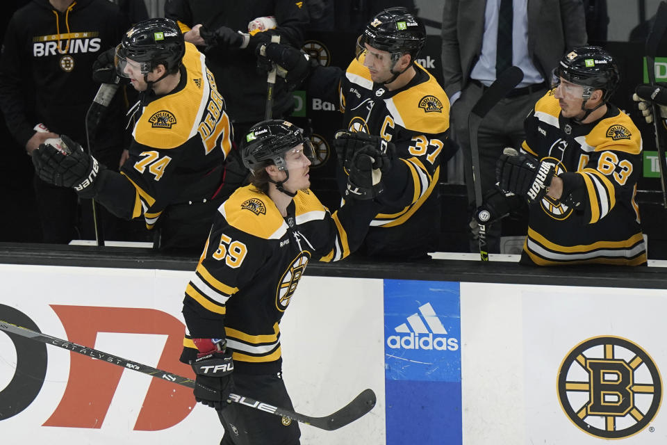 Boston Bruins left wing Tyler Bertuzzi (59) celebrates with teammates after scoring in the second period of an NHL hockey game against the Columbus Blue Jackets, Thursday, March 30, 2023, in Boston. (AP Photo/Steven Senne)