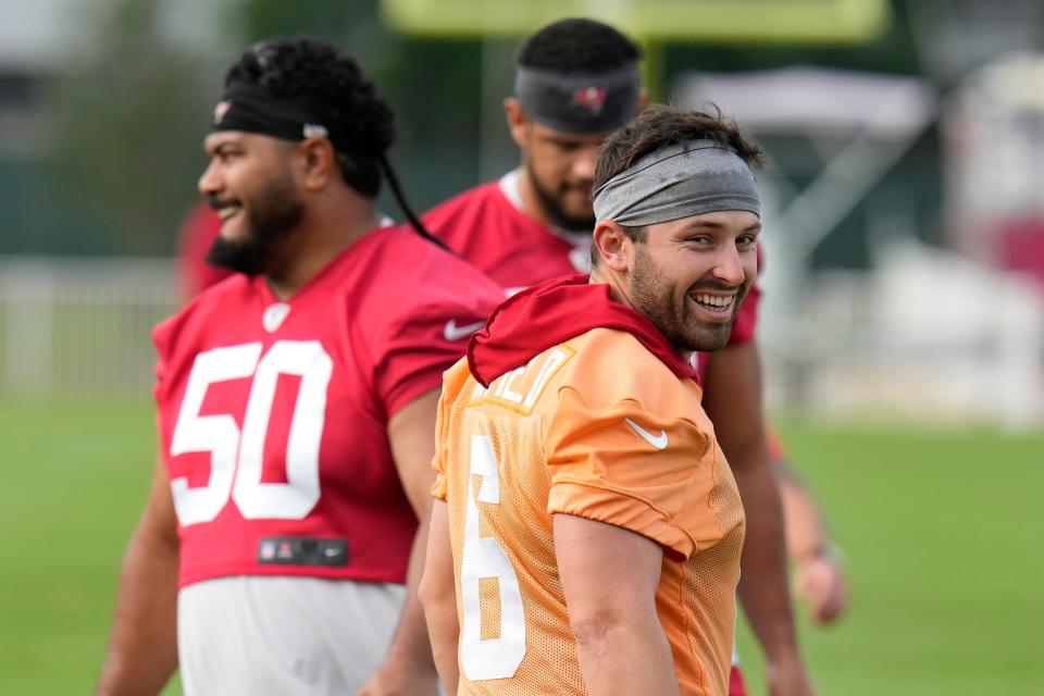 Tampa Bay Buccaneers quarterback Baker Mayfield laughs at a coach during an NFL football training camp practice Thursday, July 27, 2023, in Tampa, Fla. (AP Photo/Chris O'Meara)