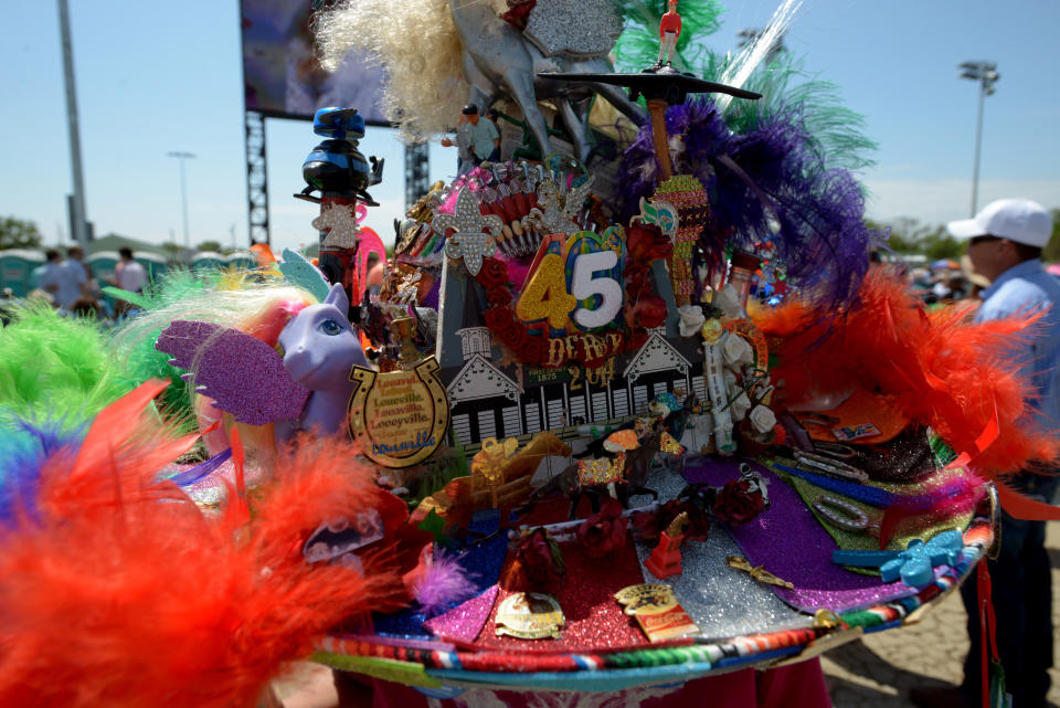 A race fan wearing a festive hat looks on from the infield prior to the derby on May 3, 2014.