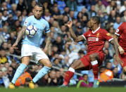 <p>Manchester City’s Nicolas Otamendi, left, and Liverpool’s Georginio Wijnaldum, right, battle for the ball </p>