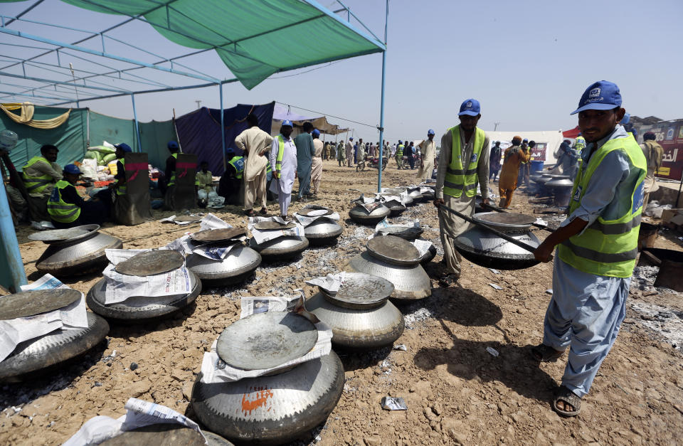 Pakistani cooks prepare food for victims of the unprecedented flooding from monsoon rains, organized by the Alkhidmat Foundation, in Jaffarabad, a district of Pakistan's southwestern Baluchistan province, Monday, Sept. 5, 2022. The U.N. refugee agency rushed in more desperately needed aid Monday to flood-stricken Pakistan as the nation's prime minister traveled to the south where rising waters of Lake Manchar pose a new threat. (AP Photo/Fareed Khan)