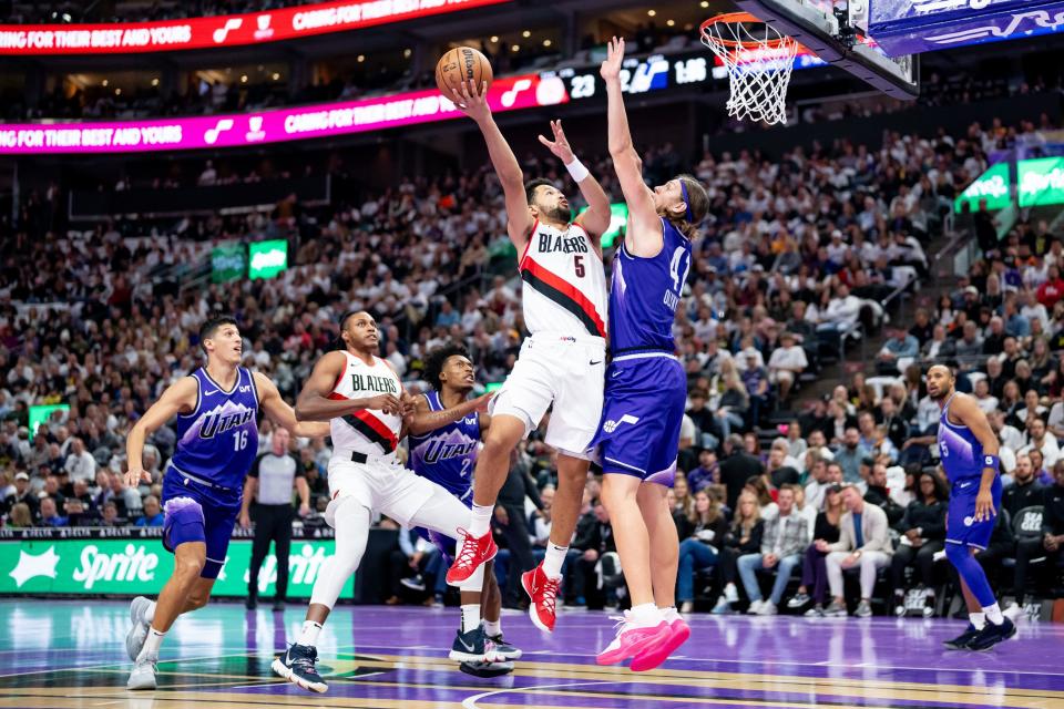 Portland Trail Blazers guard Skylar Mays (5) goes to the hoop against Utah Jazz forward Kelly Olynyk (41) during the game at the Delta Center in Salt Lake City on Tuesday, Nov. 14, 2023.