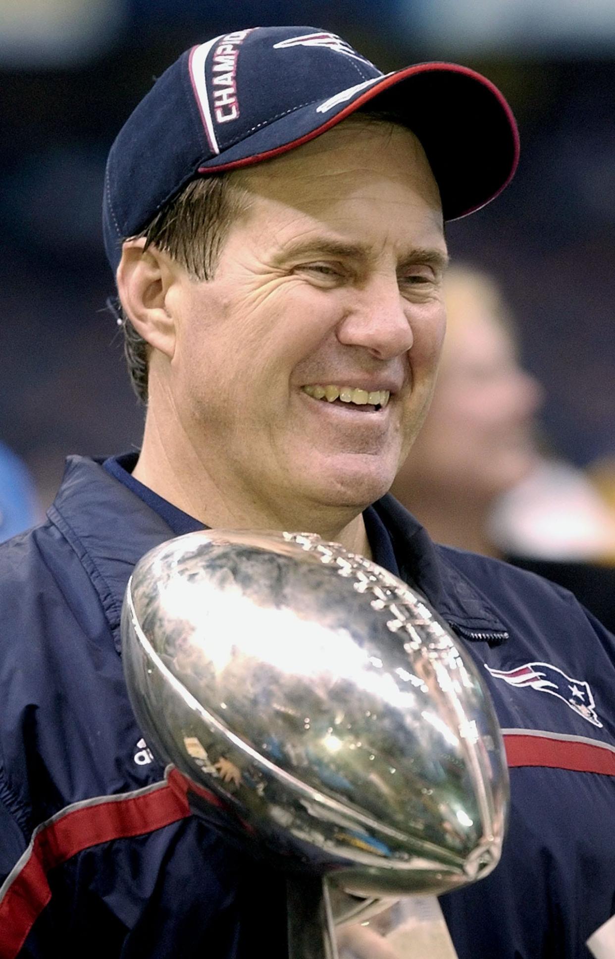 New England Patriots' coach Bill Belichick holds the Super Bowl trophy after the Patriots beat the St. Louis Rams 20-17 in Super Bowl XXXVI at the Louisiana Superdome in 2002.