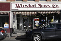 Andy Thibault, Editor and Publisher of The Winsted Citizen, carries bundles of the paper into the Winsted News Co., Friday, Feb. 3, 2023, in Winsted, Conn. At a time that local newspapers are dying at an alarming rate, longtime activist Ralph Nader is helping give birth to one. Nader put up $15,000 to help launch The Winsted Citizen and hired a veteran Connecticut journalist, Andy Thibault, to put it together. (AP Photo/Jessica Hill)