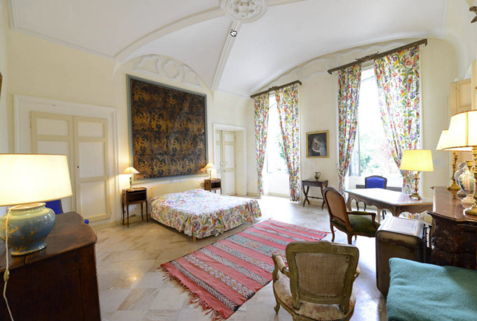 <p>Another bedroom, this one features an elaborate tapestry, wood floors and large windows (which are a rarity in castles). (Airbnb) </p>