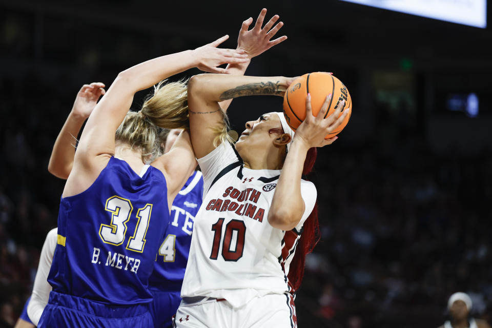 South Carolina center Kamilla Cardoso (10) looks to shoot over South Dakota State forward Brooklyn Meyer (31) during the first half of an NCAA college basketball game in Columbia, S.C., Monday, Nov. 20, 2023. (AP Photo/Nell Redmond)