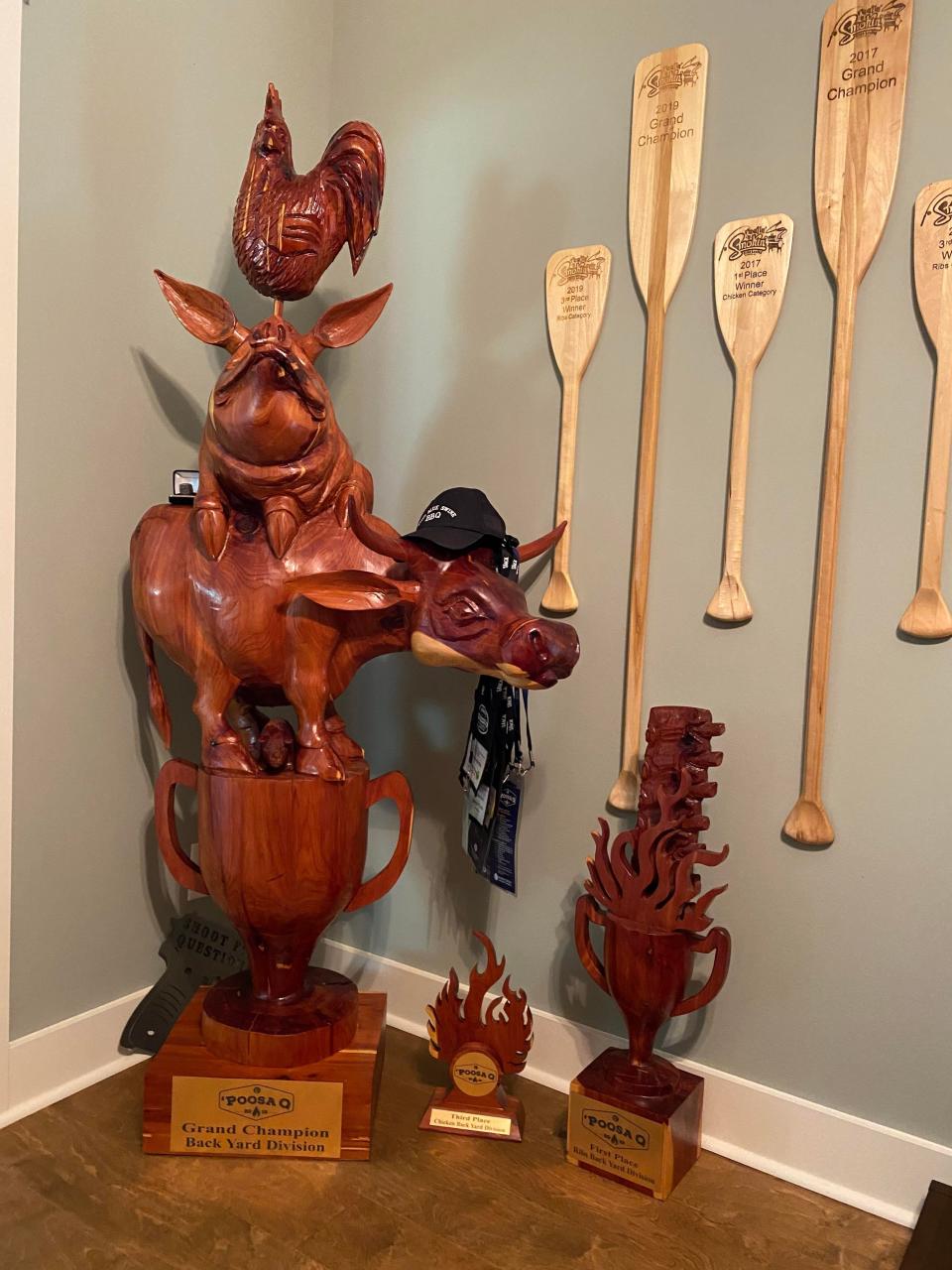Three 2019 'Poosa Q trophies - Backyard Grand Champion, First Place Ribs, and Third Place Chicken - in the Evans home in Huntsville.