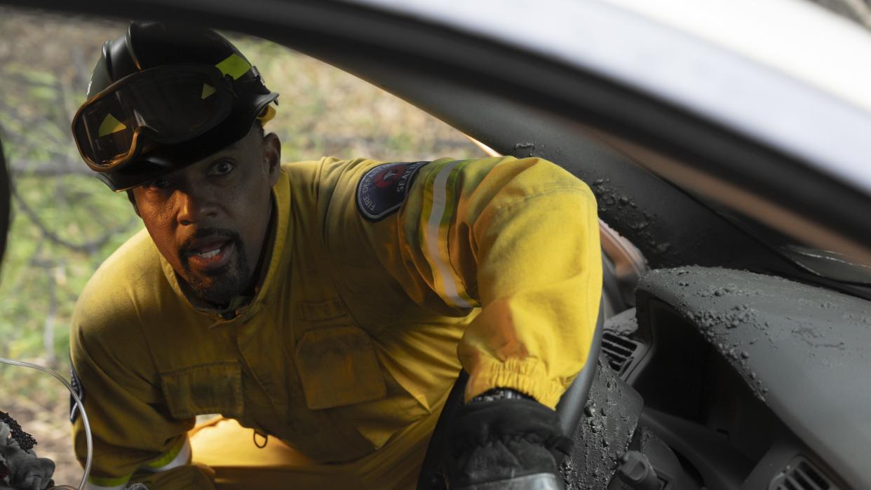  Jason Winston George as Ben in a yellow uniform in Station 19 season 7 . 