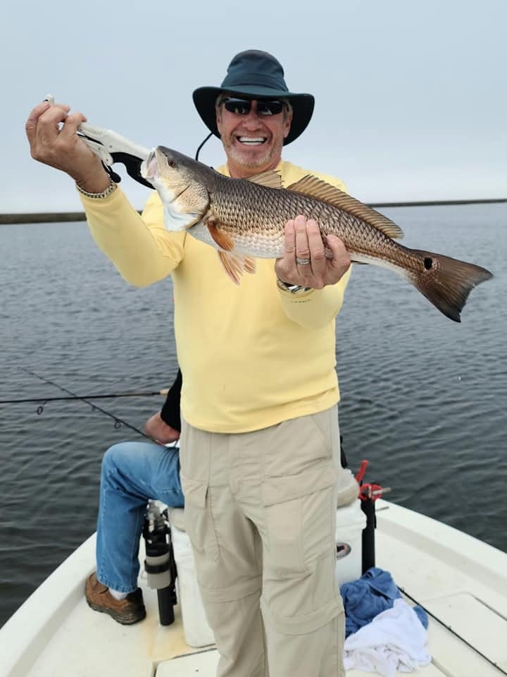 Local entrepreneur Jimmy Minor holds up a redfish keeper.