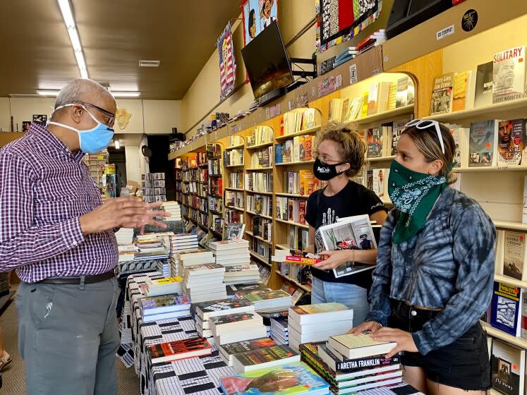 Eso Won Books co-owner James Fugate speaks with customers