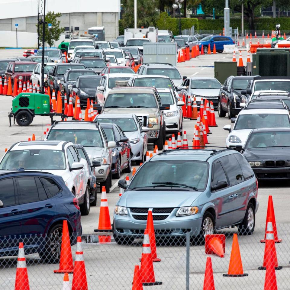 People line up inside their cars to get vaccinated at Hard Rock Stadium in Miami Gardens, Florida, on Monday, April 12, 2021. The site will no longer require appointments and have expanded COVID vaccine hours.