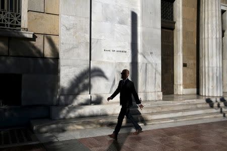 A man walks past the headquarters of Bank of Greece in Athens, August 27, 2015. REUTERS/Alkis Konstantinidis