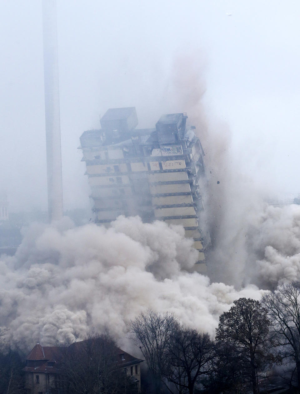 A former university tower is blown up followed by thousands of spectators in Frankfurt, Germany, Sunday, Feb. 2, 2014. (AP Photo/Michael Probst)