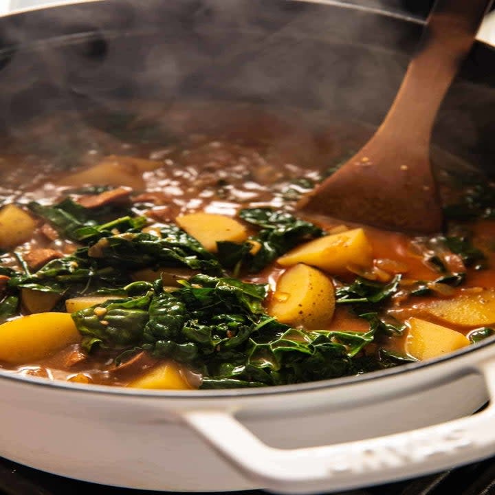 Simmering kale and potatoes in a pot