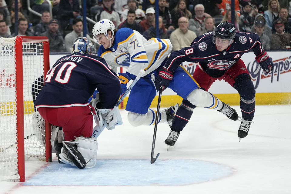 Buffalo Sabres right wing Tage Thompson (72) falls against Columbus Blue Jackets goaltender Daniil Tarasov (40), in front of defenseman Zach Werenski (8) during the first period of an NHL hockey game Friday, Feb. 23, 2024, in Columbus, Ohio. (AP Photo/Sue Ogrocki)