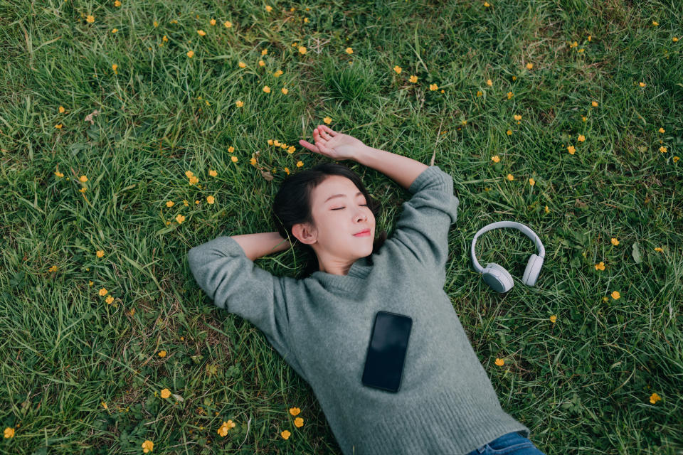 A woman takes a nap and a break from using her mobile phone. (Getty Images) 