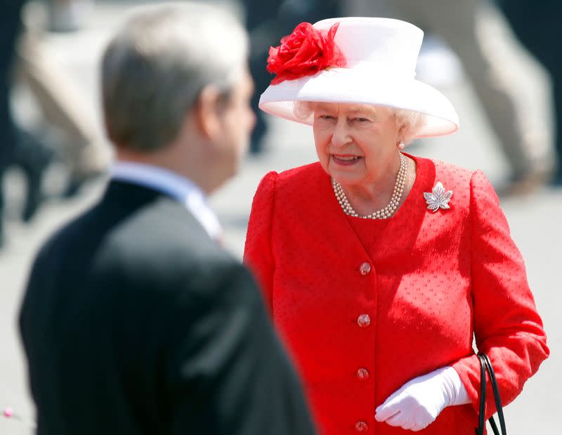 FILE PHOTO: Britain's Queen Elizabeth approaches Canada's PM Harper after inspecting the honour guard during Canada Day celebrations on Parliament Hill in Ottawa