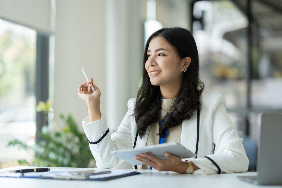 Confident businesswoman, corporate employee working online on tablet E-learning about business in finance, insurance, income, tax at the office management concept.