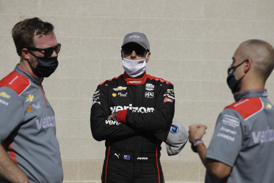 Race driver driver Will Power, middle, of Australia, talks with his crew after winning the pole for the IndyCar auto race at Indianapolis Motor Speedway in Indianapolis, Friday, July 3, 2020. (AP Photo/Darron Cummings)