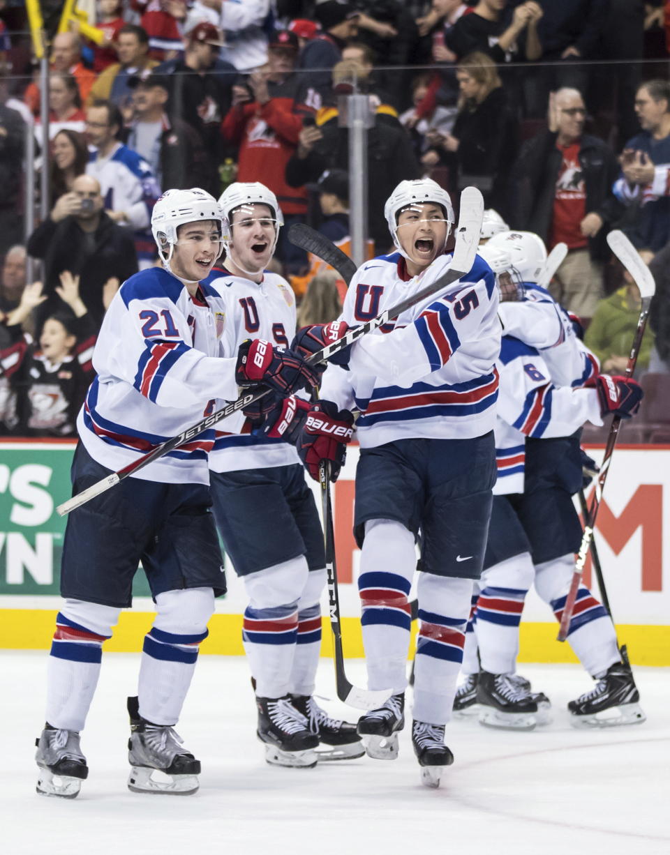 United States' Noah Cates, Mattias Samuelsson and Jason Robertson, from left, celebrate after the U.S. team defeated Russia in a world junior hockey championships semifinal in Vancouver, British Columbia, Friday, Jan. 4, 2019. (Darryl Dyck/The Canadian Press via AP)