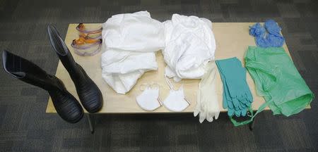 A table of specialist personal protective equipment is displayed during a National Health Service (NHS) volunteer induction and Ebola information session at the Ministry of Health in London October 15, 2014. REUTERS/Luke MacGregor