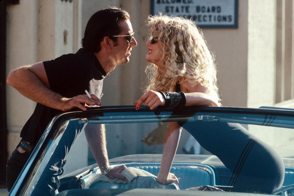 Nicolas Cage and Laura Dern smiling at each other.