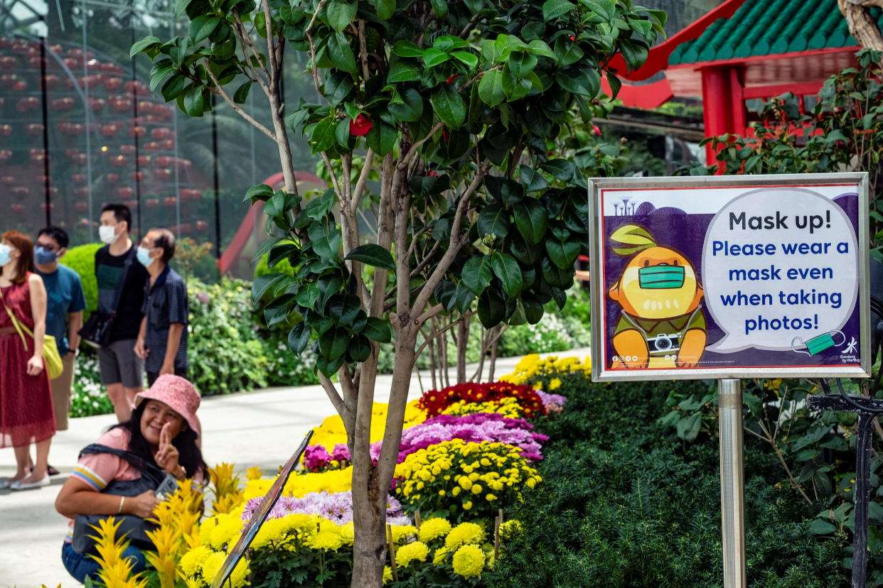 A sign reminds visitors to keep their face masks on at Singapore's Gardens by the Bay due to the ongoing COVID-19 pandemic.