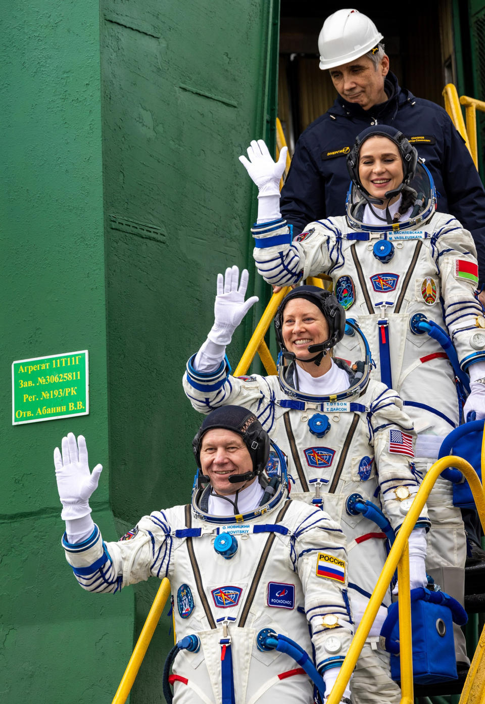 In this photo released by Roscosmos space corporation, NASA astronaut Tracy Dyson, centre, Oleg Novitsky of Roscosmos, bottom, and Marina Vasilevskaya of Belarus wave as they board to the space ship at the Russian leased Baikonur cosmodrome, Kazakhstan, Thursday, March 21, 2024. Russia's Roscosmos space agency has aborted the launch of three astronauts to the International Space Station about 20 seconds before they were scheduled to lift off. Officials say the crew is safe. The Russian Soyuz rocket was to carry NASA astronaut Tracy Dyson, Oleg Novitsky of Roscosmos and Marina Vasilevskaya of Belarus from the Russia-leased Baikonur launch facility in Kazakhstan. (Roscosmos space corporation via AP)