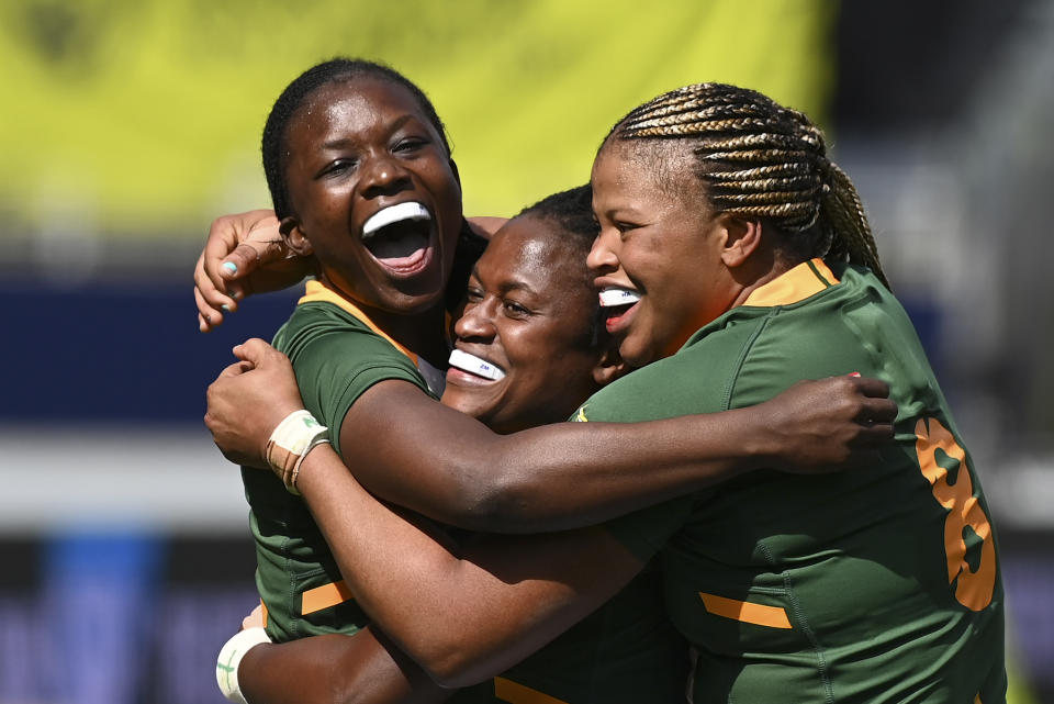 Nomawethu Mabenge, left, of South Africa celebrates her try with teammates during the Women's Rugby World Cup pool match between South Africa and France, at Eden Park, Auckland, New Zealand, Saturday, Oct.8. 2022. (Andrew Cornaga/Photosport via AP)