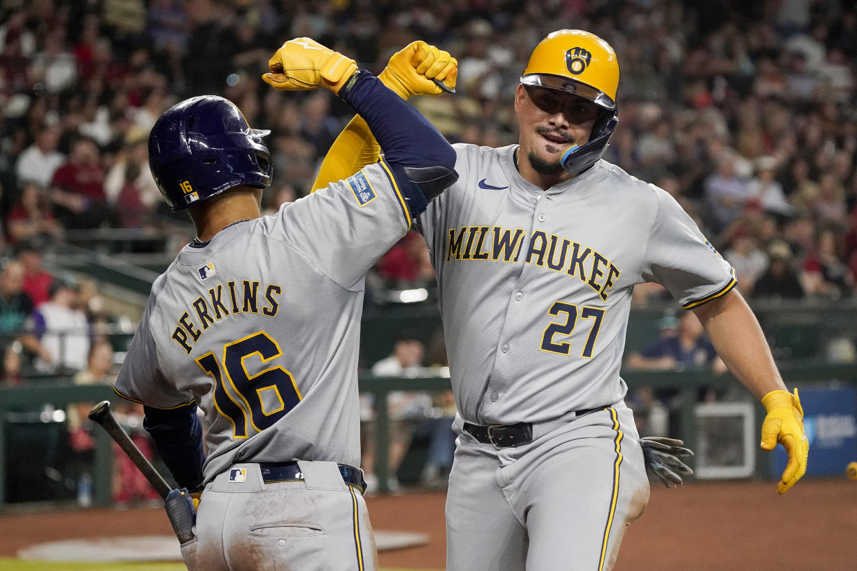 Milwaukee Brewers' Willy Adames, right, celebrates after his second home run against the Arizona Diamondbacks with Blake Perkins (16) during the fourth inning of a baseball game, Saturday, Sept. 14, 2024, in Phoenix. (AP Photo/Darryl Webb)