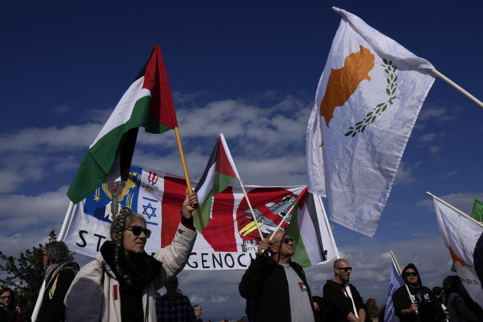 Demonstrators shout slogans and hold banners, condemning Israel's military operations inside the Gaza strip, outside the entrance of RAF Akrotiri, near southern port city of Limassol, Cyprus, on Sunday, Jan. 14, 2024. Protest organizers said the protest also condemns what they call the "use of Cyprus as a launchpad for war" after British warplanes took off from RAF Akrotiri to bomb targets in Yemen following Houthi attacks on international shipping. (AP Photo/Petros Karadjias)