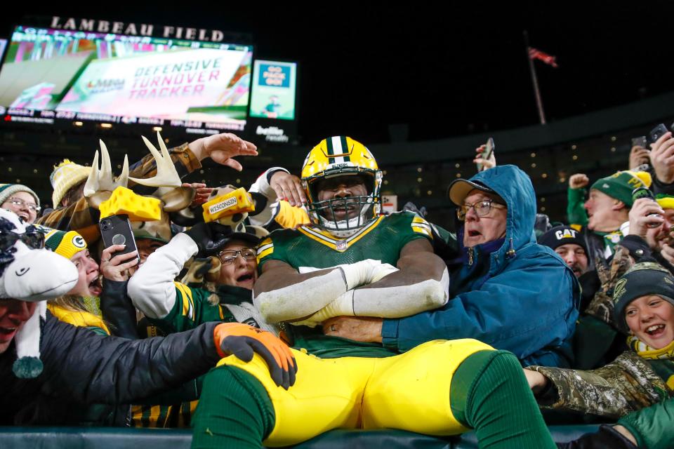 Green Bay Packers inside linebacker Krys Barnes (51) celebrates with fans a defensive stop against the Los Angeles Rams during the second half of an NFL football game, Sunday, Nov. 28, 2021, in Green Bay, Wis.