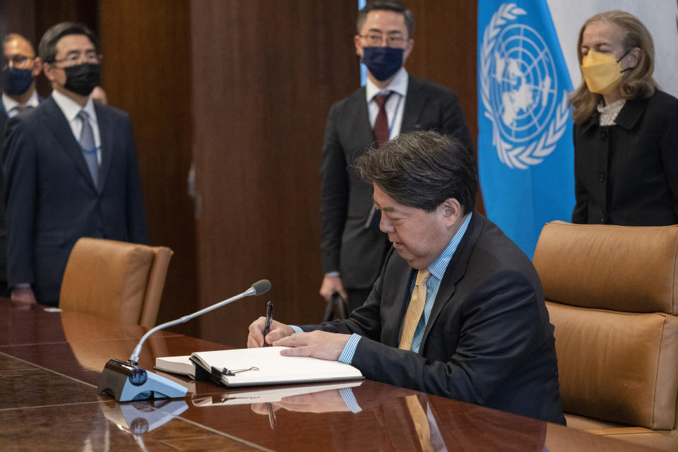 Hayashi Yoshimasa, Minister for Foreign Affairs of Japan, signs a guest book as he meets with United Nations Secretary General Antonio Guterres at United Nations headquarters, Thursday, Jan. 12, 2023. (AP Photo/John Minchillo)