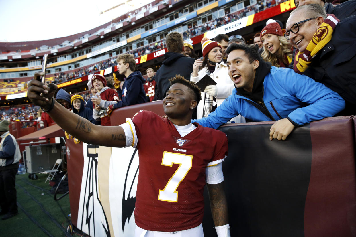 Washington Redskins quarterback Dwayne Haskins takes selfies with fans during the second half of an NFL football game against the Detroit Lions, Sunday, Nov. 24, 2019, in Landover, Md. The Redskins won 19-16. (AP Photo/Patrick Semansky)