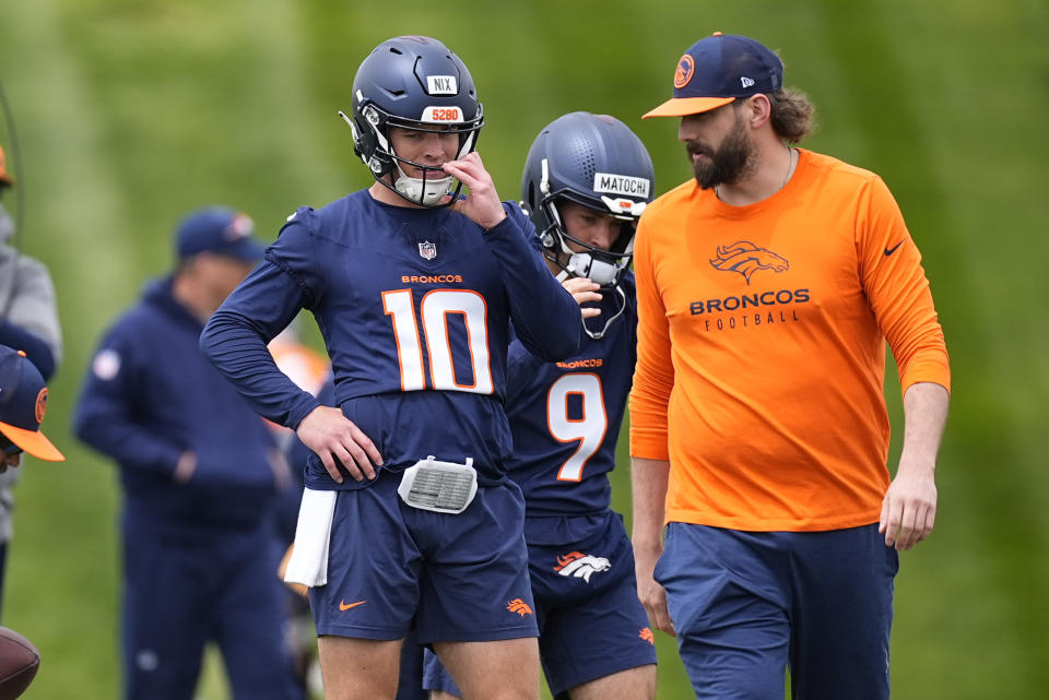 Denver Broncos quarterback Bo Nix, left, confers with quarterback coach Davis Webb during the NFL football team's rookie minicamp, Saturday, May 11, 2024, in Centennial, Colo. (AP Photo/David Zalubowski)