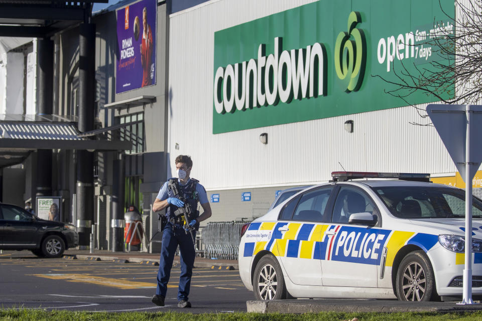 FILE - In this Saturday, Sept. 4, 2021, file photo, an armed police officer stands outside a Countdown supermarket in Auckland, New Zealand. Ahamed Aathil Samsudeen grabbed a kitchen knife from store shelf and begins stabbing shoppers while chanting “Allahu akbar” — meaning “God is great" at the supermarket on Sept. 3, 2021. (AP Photo/Brett Phibbs, File)