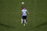 Argentina's Ezequiel Lavezzi and Chile's Francisco Silva (rear) jump for the ball during their Copa America 2015 final soccer match at the National Stadium in Santiago, Chile, July 4, 2015. REUTERS/Ricardo Moraes