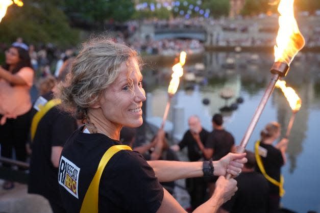 Dr. Lynn Taylor, director of the RI Defeats Hep. C initiative, pictured participating in an annual "WaterFire" event to raise awareness on World Hepatitis Day.