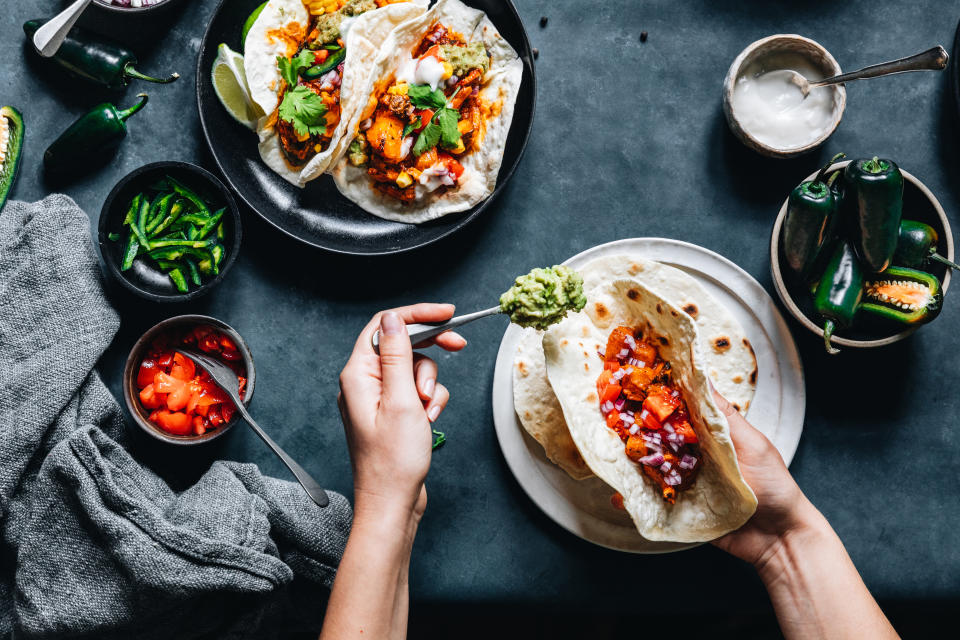 woman making vegetarian tacos at home