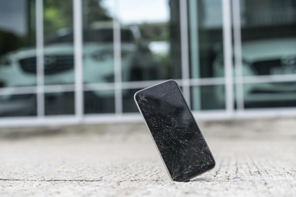 Mobile phone falling and crashes on asphalt