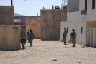 Afghan Uniform Police and soldiers from the U.S. Army 4th Brigade Combat Team provide 360-degree security outside a compound during training at National Training Center at Ft. Irwin, California, U.S. on September 18, 2011. Courtesy Austin Pritchard/U.S. Army/Handout via REUTERS