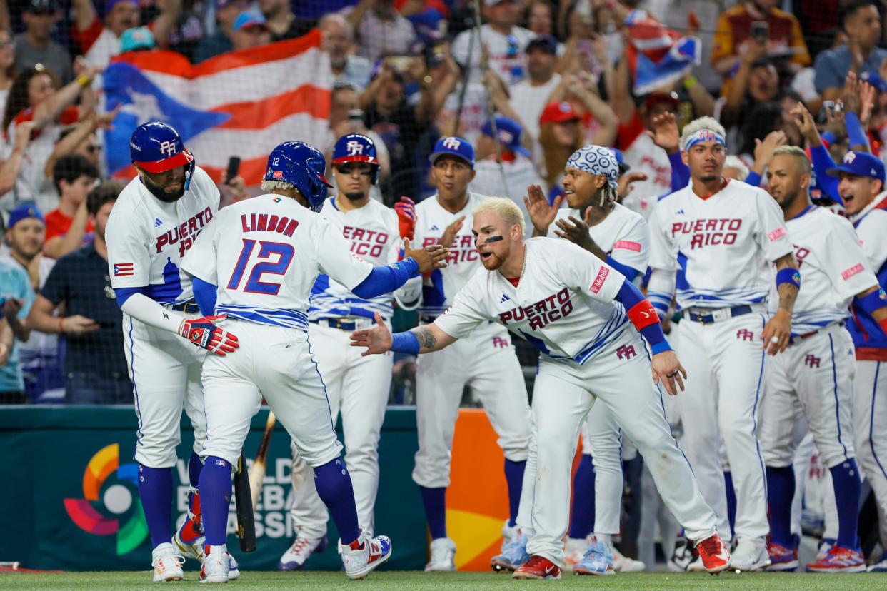 Mar 11, 2023; Miami, Florida, USA; Puerto Rico shortstop Francisco Lindor (12) celebrates with teammates after scoring during the fifth inning against Nicaragua at LoanDepot Park. Mandatory Credit: Sam Navarro-USA TODAY Sports