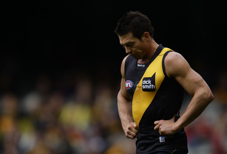 Ben Cousins of the Tigers leaving the field looking dejected.