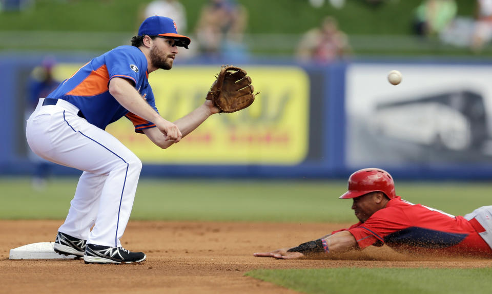 FILE - In this March 7, 2014, file photo, St. Louis Cardinals' Kolten Wong, right, steals second as New York Mets second baseman Daniel Murphy bobbles the throw during the first inning of an exhibition spring training baseball game in Port St. Lucie, Fla. Murphy is proud he put fatherhood ahead of baseball, and New York Mets manager Terry Collins thinks criticism his second baseman received for taking paternity leave this week was unfair. Murphy made his season debut Thursday, April 3, three days after the birth of son Noah. (AP Photo/Jeff Roberson, File)