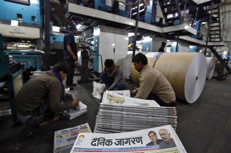 Employees sort Dainik Jagran newspapers inside its printing press in Noida, on the outskirts of New Delhi February 26, 2014. REUTERS/Anindito Mukherjee