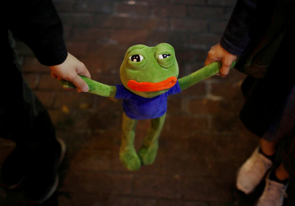 Anti-government protesters hold Pepe the frog while forming a human chain protest on a New Year's Eve in Hong Kong, China, December 31, 2019. REUTERS/Navesh Chitrakar