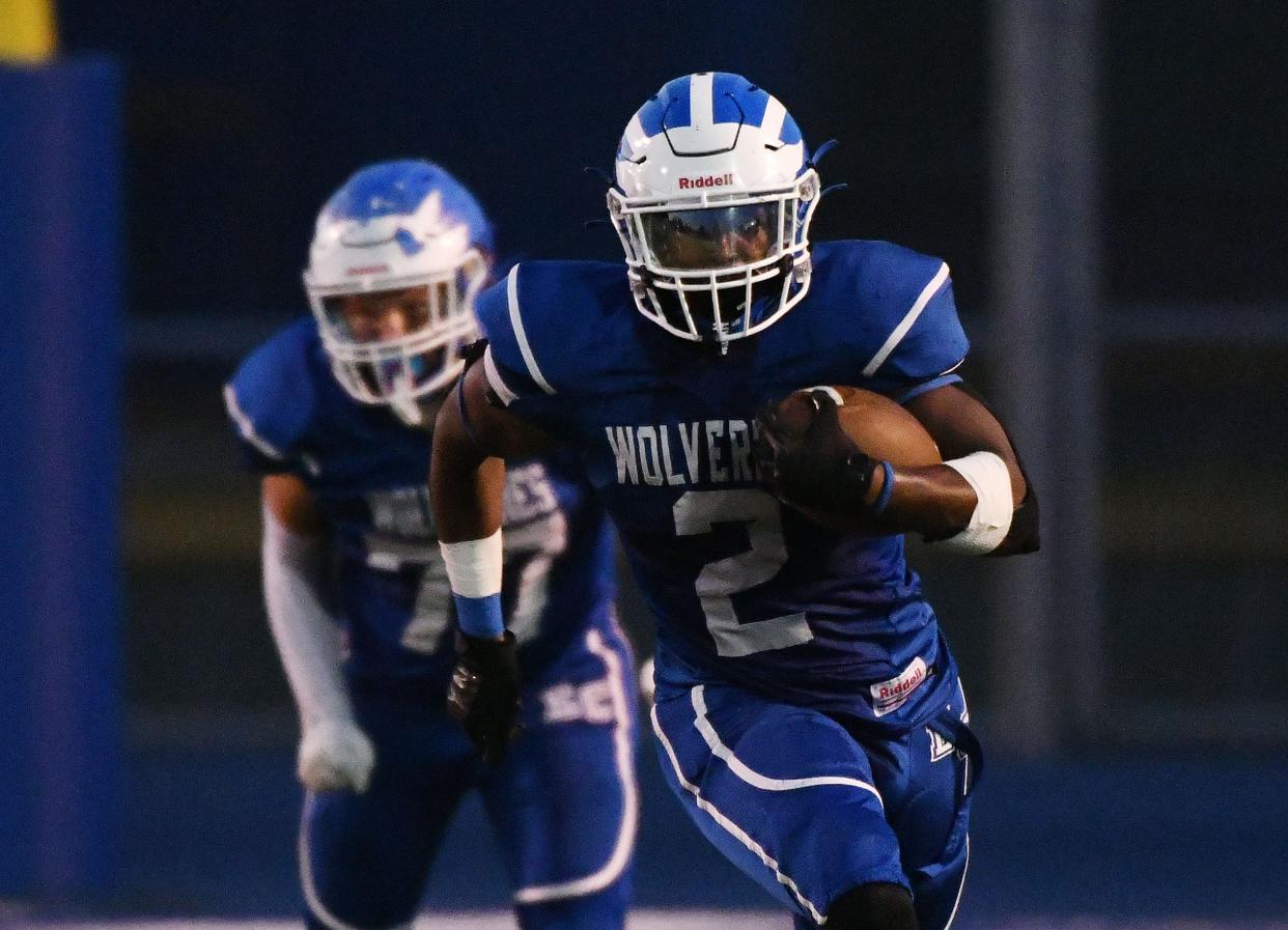 Ellwood’s Elijah Palmer-McCane picks up some yards during Friday night’s game at Ellwood.