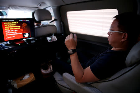 Ferdinand Tan, 53, wealth coach and motivational speaker, rehearses his lines in his van, while on his way to a speaking engagement, in Cainta City, Rizal province, Philippines, November 30, 2018. Tan customised his van to become a mobile office so he could be productive on the road. "One thing I've learned in life is you cannot control the things you cannot control, but you can change the way you respond to the situation. I cannot control the traffic, no one can really solve the traffic. So instead of complaining about it, I try to maximise and use it in order for me to leverage off the traffic." REUTERS/Eloisa Lopez