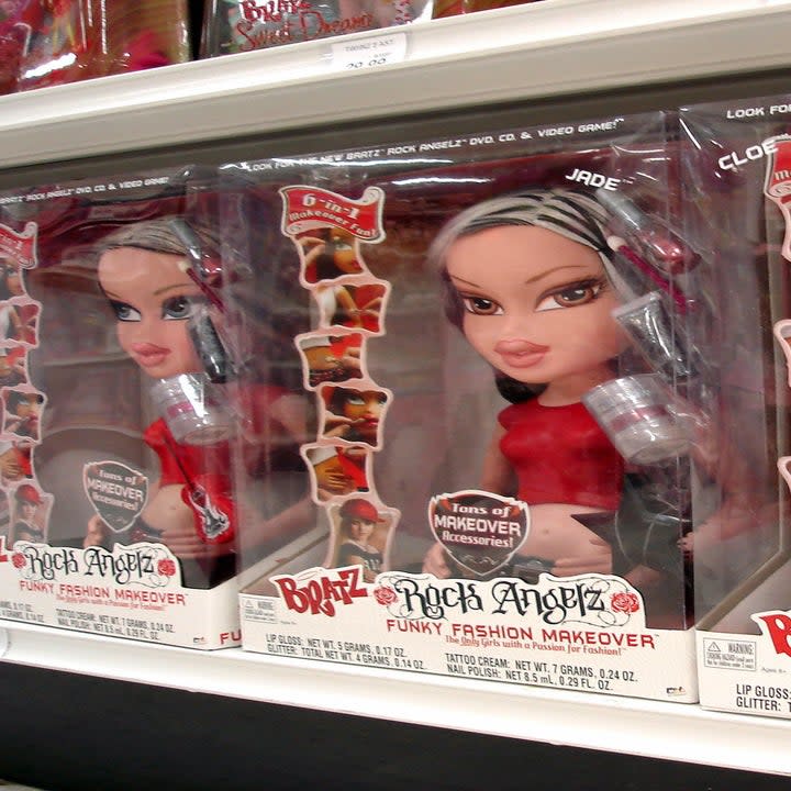 a shelf of bratz dolls