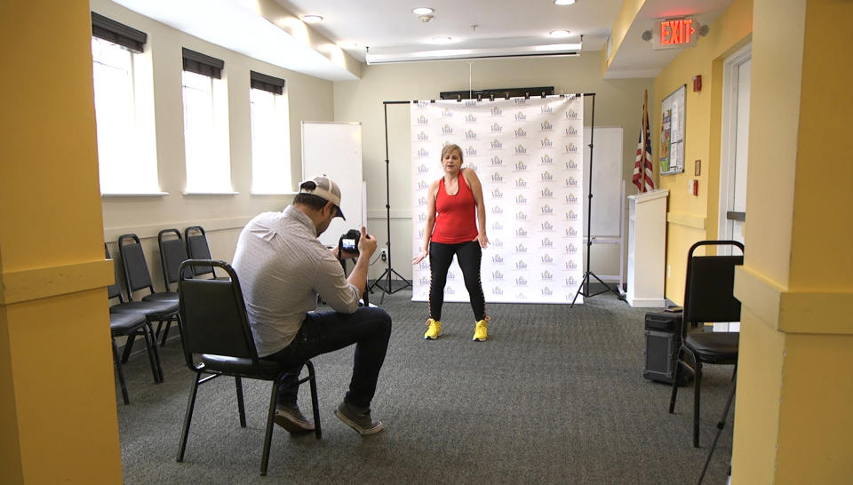 In this Tuesday, March 17, 2020 photo, dance instructor Lola Jaramillo records a Zumba and exercise lesson in Washington, that will be uploaded in the social media accounts of Vida Senior Center, a nonprofit that serves Washington’s older Hispanic community. (AP Photo/Federica Narancio)